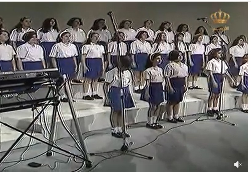 A children's choir singing on stage